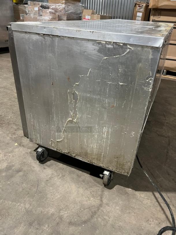 Continental 3 Door Under Counter Lowboy Cooler on casters, visible wear and scratches, includes racks, 115V 1Phase.