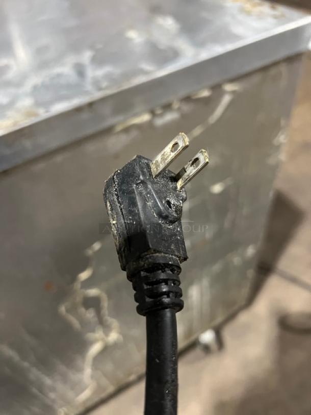 Continental 3-door under-counter lowboy cooler with racks, visible power cord; on casters, 115V 1-phase, used condition.