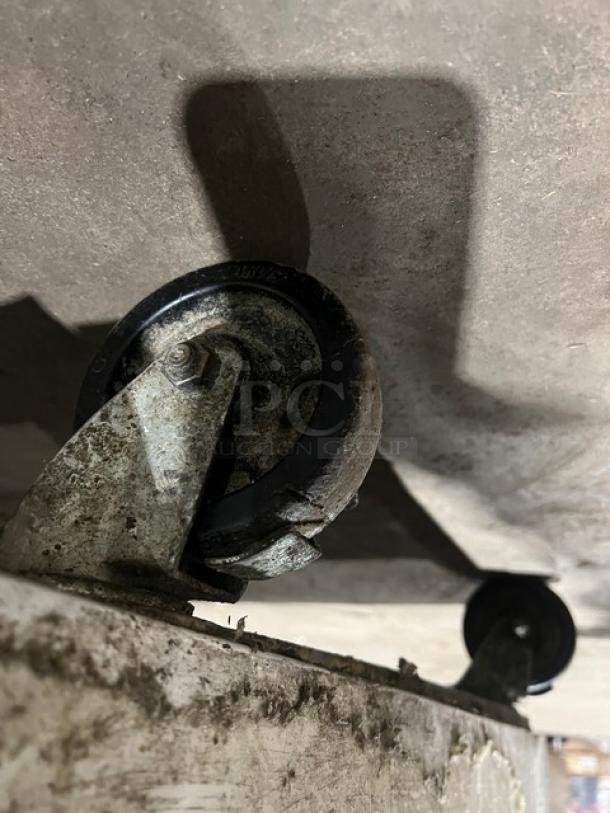 Continental 3 door under counter lowboy cooler on casters, featuring racks and a 115V 1Phase power supply.