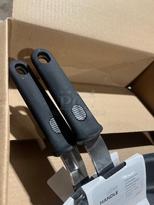 Brand new Vollrath Easy Grip Heavy Duty Frying Pan, Model 562412, with ergonomic handles, in original packaging.