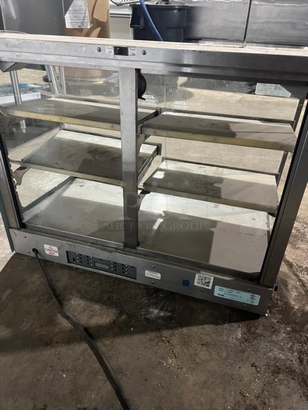 Vendo 3-tier heated merchandiser food warmer, model HFDC00002. Electric powered. Visible wear, serial 142345H.
