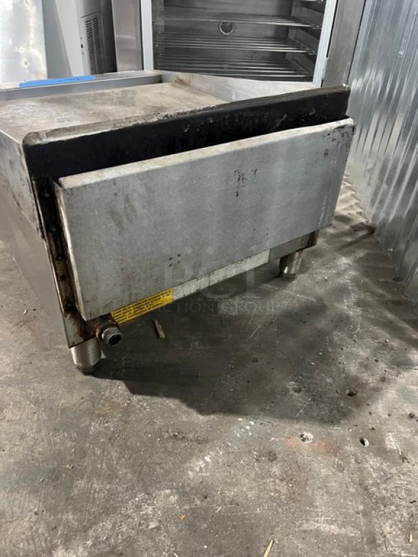 Starmax 24" natural gas countertop flat griddle on legs, thermostatic control, stainless steel, signs of wear, label visible.