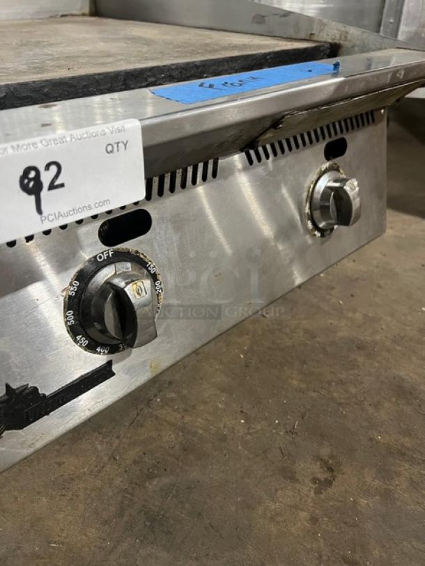 Starmax 24" natural gas flat griddle with thermostatic controls. Countertop model on legs, features temperature dials.