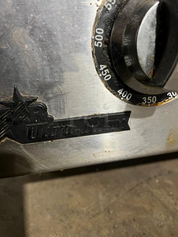 Star Max Ultra-Max natural gas flat griddle, 24-inch, thermostatic control, on legs. Dial shows temperature settings. Used condition.