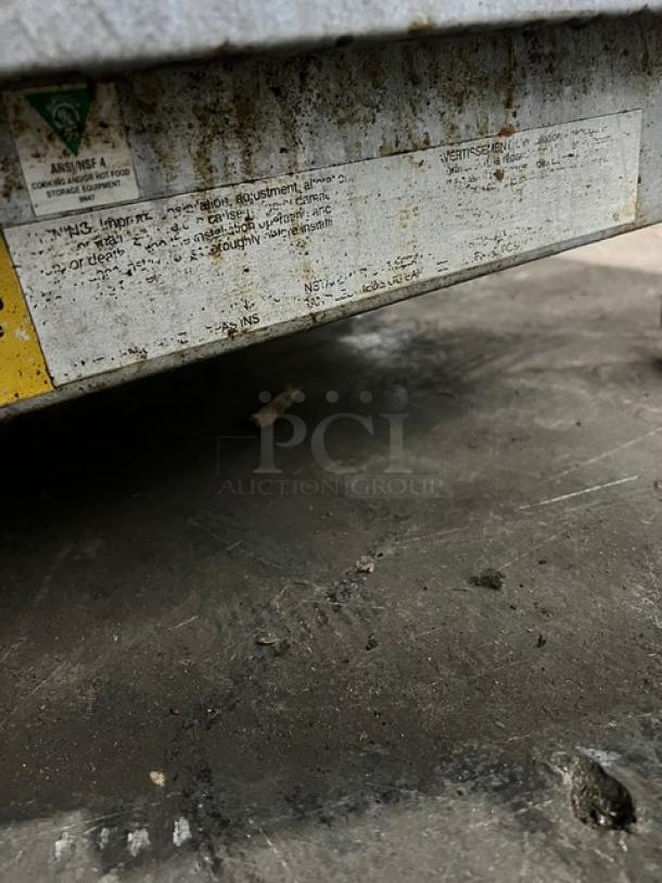 Starmax natural gas flat griddle, 24 inch, thermostatic control, countertop model on legs, worn label with NSF certification.