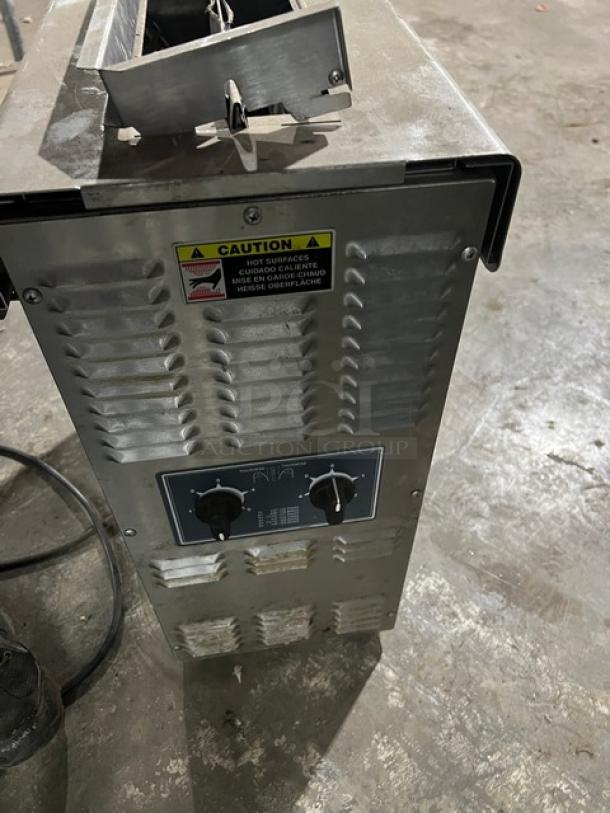 Antunes VCT-1000CV stainless steel electric contact toaster, double-sided toasting, caution label, control knobs, on legs.