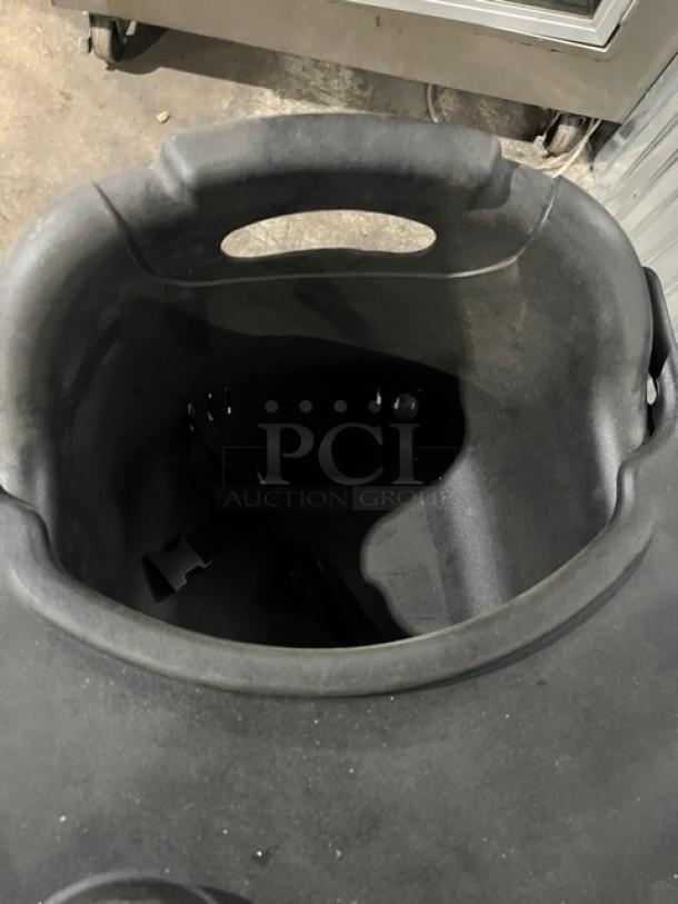 Commercial black high chair with tray, durable plastic, gently used, suitable for restaurant settings.