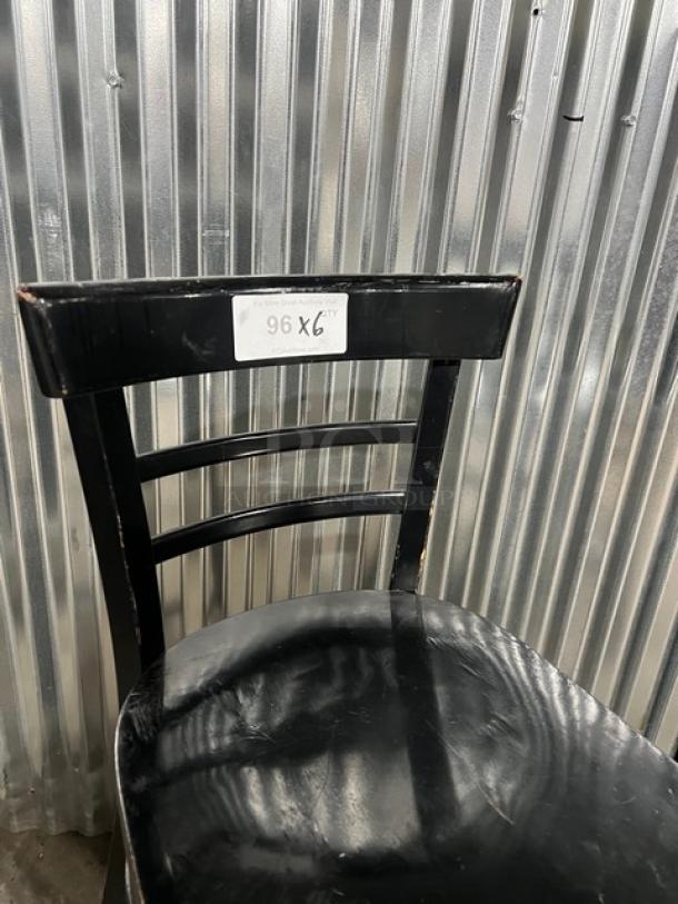 Black bar-height chair, commercial-grade, with slight wear, sturdy build, marked "96X6" on backrest tag.