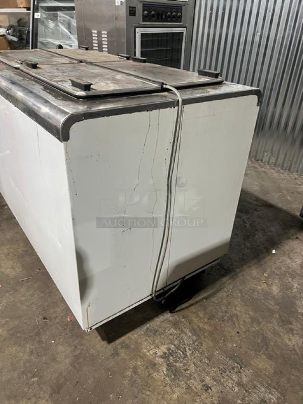 Kelvinator commercial white ice cream dipping cabinet with flip-top lid, on casters. Used condition, some surface wear.