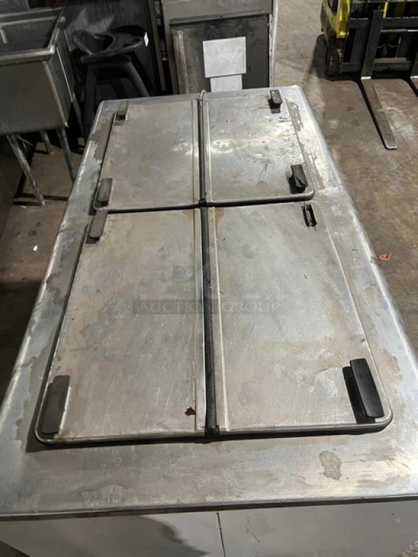 Kelvinator commercial ice cream dipping cabinet with flip-top lid, white finish, on casters, used condition.