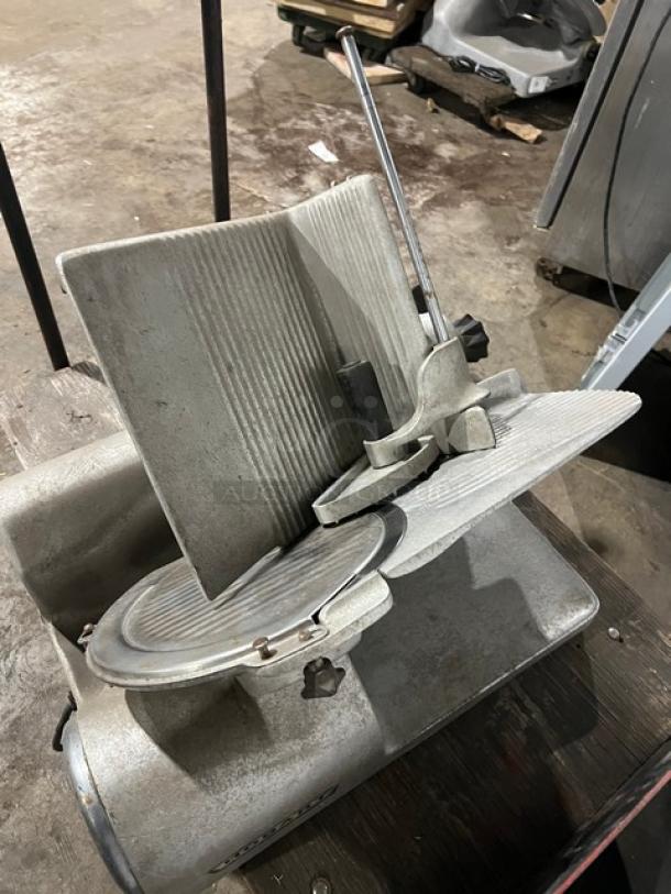 Hobart 1612 commercial electric deli meat slicer, metal finish, in used condition, with adjustable slicing mechanism.