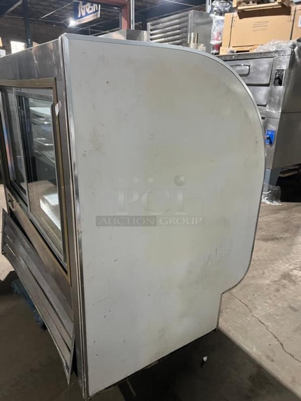 Leader commercial stainless steel curved glass bakery display case, 3-tier, rear sliding doors, poly-coated rack, Model 115V 1 Phase.