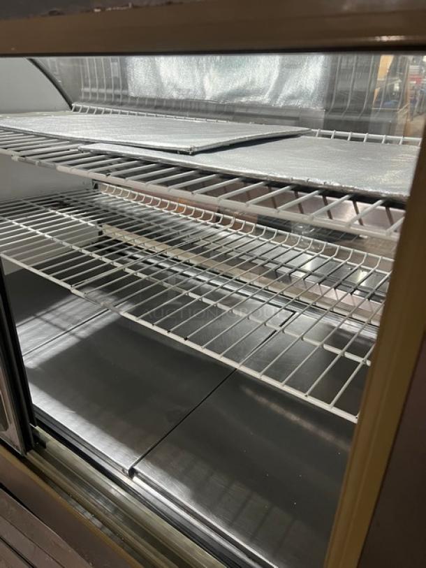 Leader Commercial Stainless Steel 3-Tier Bakery Display Case, Model 115V 1 Phase. Features rear glass sliding doors and poly coated wired racks.