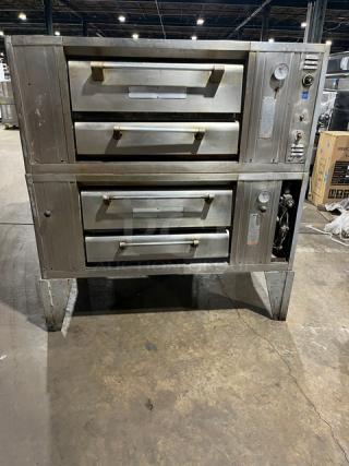 Bari M6PS natural gas double-stacked pizza oven, 4-pie capacity, on legs. Features control panel, sturdy condition. Model 2446.