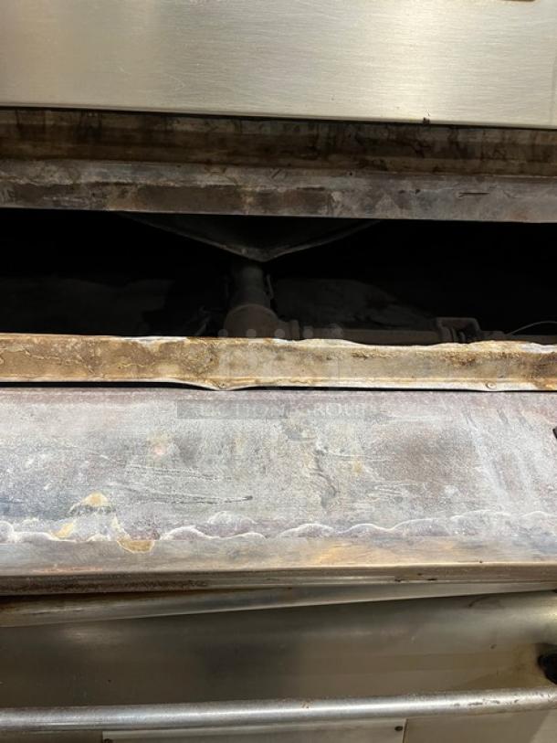 Bari M6PS natural gas pizza oven, double stacked, fits 4 pies, serial 2446, on legs, visible use on baking surface.