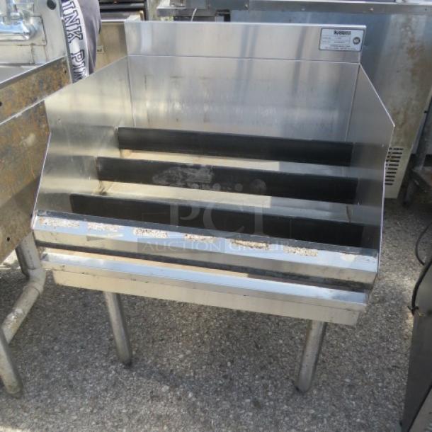 Krowne stainless steel underbar liquor display, 24x24x35 inches, features tiered shelving, used condition.