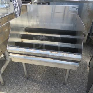 Krowne stainless steel underbar liquor display, 24x24x35 inches, features tiered shelving, used condition.