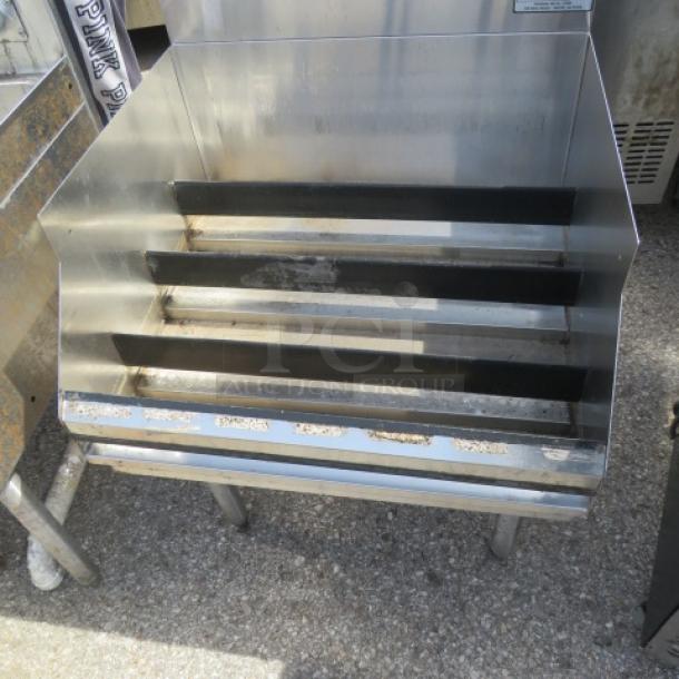 Stainless steel Krowne underbar liquor display, 24"x24"x35", three-tier shelves, slightly worn, suitable for bars.