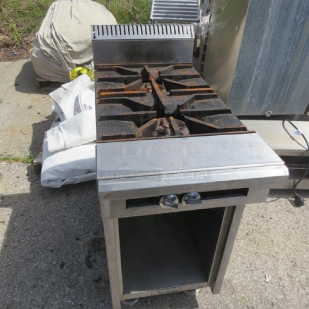 US Range natural gas 2 burner range, model 36-7, with under storage. Dimensions: 18x38x41 inches. Slight wear visible.