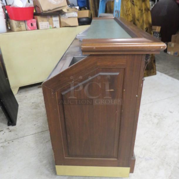 FWE portable bar with mahogany trim, stainless steel under shelf, under storage, ice well, and bottle rail on casters. Model AS-CB-6-MW.