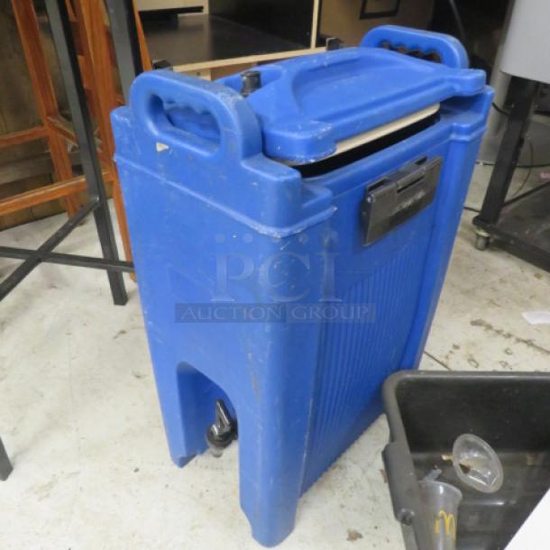Carlisle 5 Gallon Portable Beverage Dispenser, blue, durable plastic, used condition, with carrying handles and front spigot.