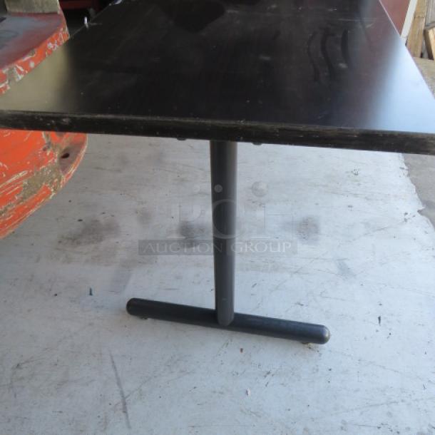 Heavy-duty brown laminate Kimball folding table, 66x24x29 inches, shown with sturdy black base. Minimal wear visible.