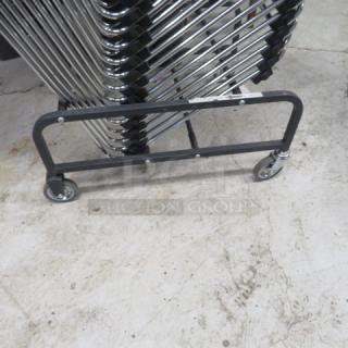 Metal chair cart on casters, no chairs, sturdy frame, smooth wheels, used condition, ideal for transporting stacked chairs.