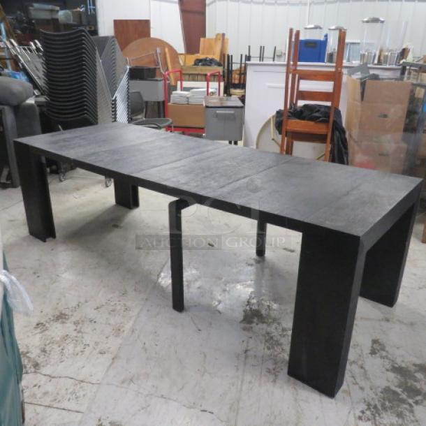 Extendable dining table with 2 end pieces and 4 inserts, measuring up to 8 feet long, in excellent condition, 98x37.5x30 inches.