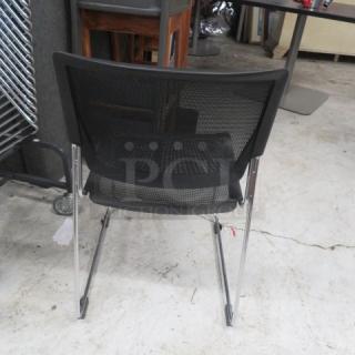 Stackable metal and black poly event chair, mesh back, chrome legs, modern design, used condition.
