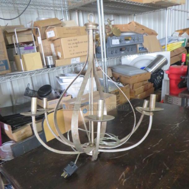 Gold color pendant chandelier with six bulb holders, vintage style, gently used condition. No visible brand markings.