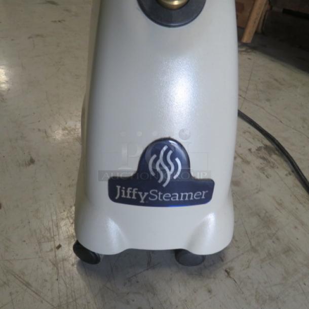 Jiffy Steamer Model J-2000, 120 Volt, in good condition. Shows Jiffy Steamer logo on white base with wheels.