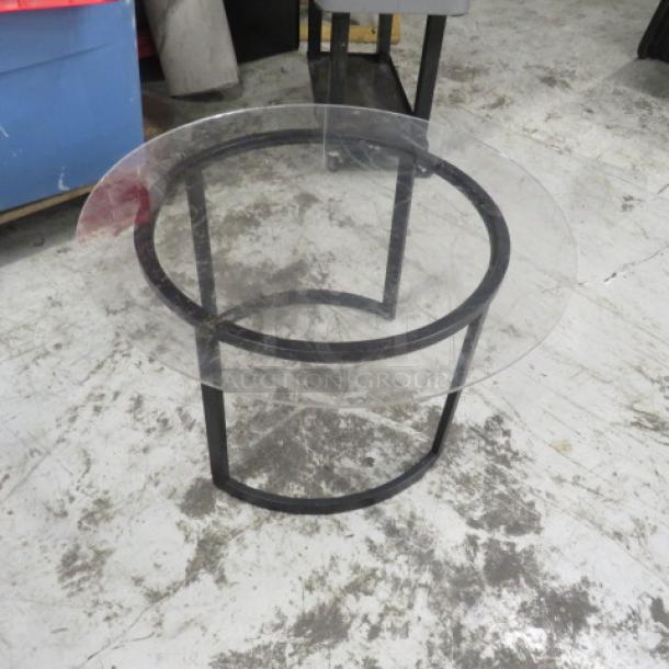 Black metal table base with round plexiglass top, 30x17 inches. Sturdy design, suitable for modern decor.