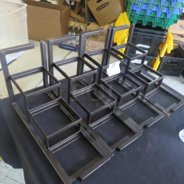 Heavy metal display stands, dimensions 13x5x8 inches, set of 4. Sturdy construction, suitable for retail or exhibition use.