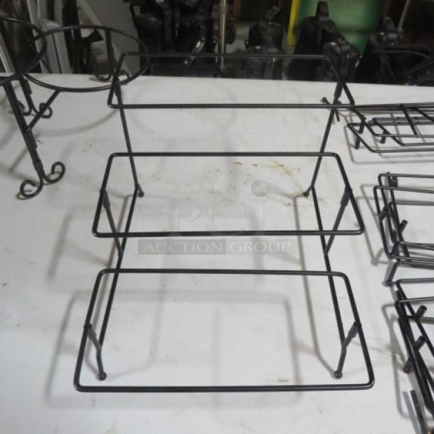 Black metal buffet holder with two tiers, sturdy design. Item price: $27.99 each. Condition appears used. 4XBID label visible.