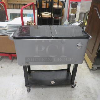 Pearington 80 quart rolling ice/beverage cart with under shelf and bottle opener. Gray and black finish. Excellent condition.