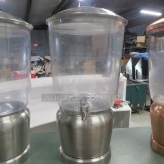 Stainless steel and poly beverage dispenser with spigot, clear polycarbonate top, and brushed metal base, in good condition.