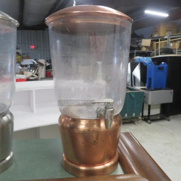 Copper color poly beverage dispenser with spigot. Clear top, sturdy base. Suitable for events or catering. Good condition.