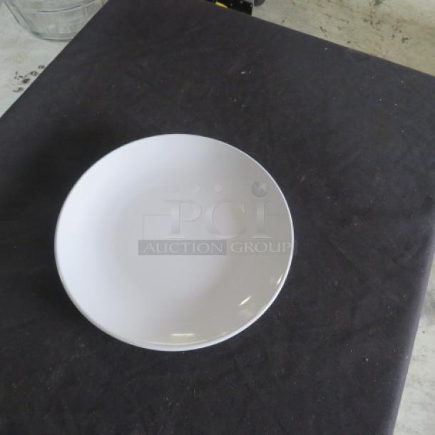 New 10.5-inch Acopa bright white plate on display. Glossy finish, excellent condition, perfect for dining or decor.