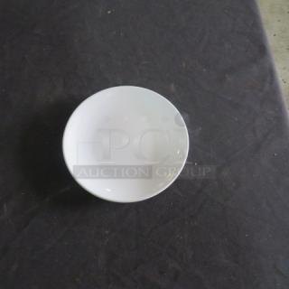 New Acopa 8-1/4 inch bright white plate on black surface, pristine condition.