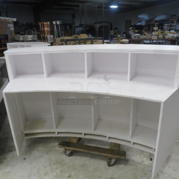 White wooden curved portable bar or hostess stand with under storage. Measures 77x30x42 inches. Used condition.
