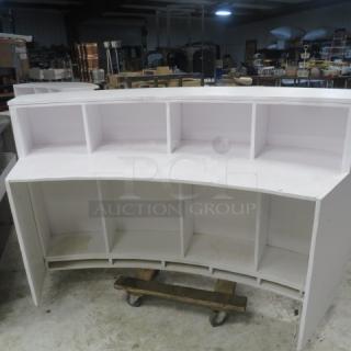 White wooden curved portable bar or hostess stand with under storage. Measures 77x30x42 inches. Used condition.