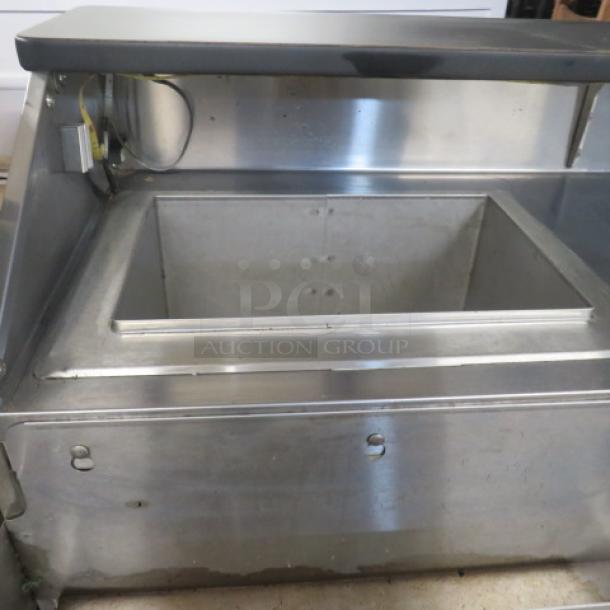Portable bar with two stainless steel ice wells, black laminate serving shelf, bottle rails, and casters. Size: 95x31x46 inches.