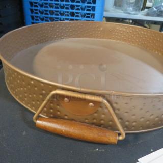 Copper-colored hammered round serve tray, 16.5x2.5 inches, features wooden handles, excellent condition.