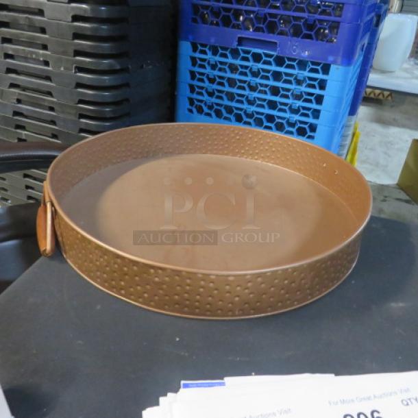 Copper color hammered round serve tray, 16.5x2.5 inches, excellent condition, textured interior and handles.