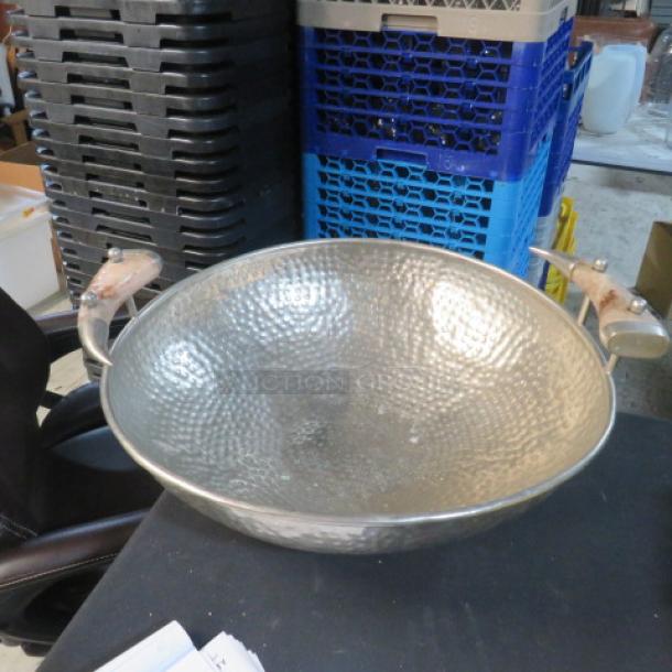 Hammered round serve bowl with antler handles, 20.5 inches. Unique design, excellent condition, ideal for rustic decor.