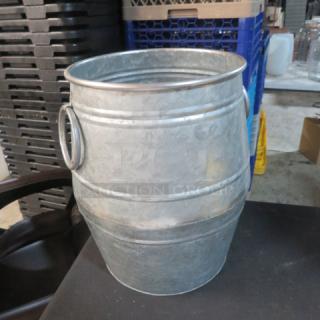 Galvanized 14-inch barrel, metal construction, dual side handles, vintage industrial style, good condition.