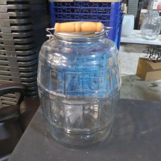 Glass barrel jar with lid and wooden handle. Clear glass, barrel-shaped design. Excellent condition, perfect for storage.