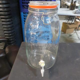 Savannah Glassware beverage dispenser, clear glass, with lid and spout. Features embossed branding, used condition.
