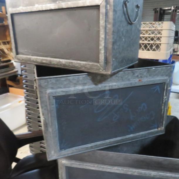Assorted metal boxes with chalkboard fronts, varying sizes, metal handles, industrial style, used condition.