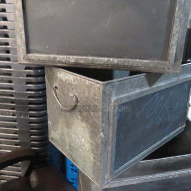 Assorted size metal boxes with chalkboard fronts, featuring handles, in used condition. Ideal for labeling and storage.